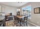 Charming dining area with a wooden table, upholstered chairs, and plenty of natural light at 3254 S Ansley Dr, New Palestine, IN 46163