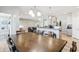 Open concept dining area with wooden table, chairs, and views of living spaces at 3254 S Ansley Dr, New Palestine, IN 46163