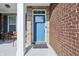 Charming blue front door with decorative glass and stone accents at 3254 S Ansley Dr, New Palestine, IN 46163