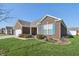 Well-maintained home featuring a brick facade and manicured landscaping at 3254 S Ansley Dr, New Palestine, IN 46163