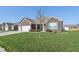 Beautifully landscaped home with a large front yard and blue shutters at 3254 S Ansley Dr, New Palestine, IN 46163