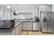 Well-designed kitchen boasting stainless steel refrigerator, gray cabinets and dark counter tops at 3254 S Ansley Dr, New Palestine, IN 46163