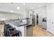 Open kitchen and bar with seating, stainless appliances, and modern fixtures at 3254 S Ansley Dr, New Palestine, IN 46163