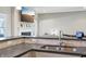 Modern kitchen with stainless appliances, gray counter-tops and a view to the living room with fireplace at 3254 S Ansley Dr, New Palestine, IN 46163