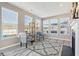 Bright living room with many windows, fireplace, gray chairs, and a stylish rug at 3254 S Ansley Dr, New Palestine, IN 46163