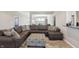 Comfortable living room with a large sectional sofa and patterned ottoman at 3254 S Ansley Dr, New Palestine, IN 46163