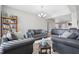 A cozy living room featuring a grey sofa set, natural light, and wood-style flooring at 3254 S Ansley Dr, New Palestine, IN 46163