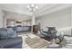 An inviting living room with an open floor plan, light gray walls, modern furniture and wood floors at 3254 S Ansley Dr, New Palestine, IN 46163