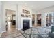 Spacious living room with fireplace, open layout, and views into dining and sitting rooms at 3254 S Ansley Dr, New Palestine, IN 46163