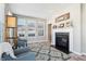 Cozy living room featuring a fireplace, neutral walls, light gray floors, and comfy furniture at 3254 S Ansley Dr, New Palestine, IN 46163