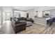 A spacious living room with modern decor, gray sectional sofa, and a combined kitchen at 3254 S Ansley Dr, New Palestine, IN 46163