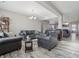 A bright and airy living room with gray sofas, a small table and an open floor plan at 3254 S Ansley Dr, New Palestine, IN 46163