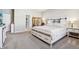 Cozy main bedroom showcases a barn door style bedframe, soft carpet, and neutral tones at 3254 S Ansley Dr, New Palestine, IN 46163