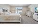 Comfortable main bedroom features a spacious layout, neutral carpet, and a barn door style bedframe at 3254 S Ansley Dr, New Palestine, IN 46163
