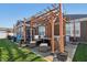 Backyard patio space features wooden pergola with outdoor furniture at 3254 S Ansley Dr, New Palestine, IN 46163