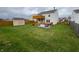 Spacious backyard featuring a deck, hot tub, storage shed, green grass, and fenced in perimeter at 373 Springfield Cir, Greenwood, IN 46143