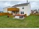 Beautiful backyard featuring a wood deck with hot tub, green grass, and surrounding wood fence at 373 Springfield Cir, Greenwood, IN 46143