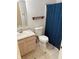 Standard bathroom featuring single sink vanity, white toilet, and shower with blue patterned shower curtain at 373 Springfield Cir, Greenwood, IN 46143