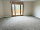 Spacious bedroom with neutral carpet, French doors leading to a deck, and plenty of natural light at 373 Springfield Cir, Greenwood, IN 46143