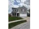 Charming two-story home featuring a brick facade, well-manicured lawn, and a two-car garage at 373 Springfield Cir, Greenwood, IN 46143