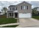 Charming two-story home featuring a brick facade, well-manicured lawn, and a two-car garage at 373 Springfield Cir, Greenwood, IN 46143