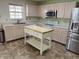 Bright kitchen featuring light wood cabinets, stainless steel appliances, and a kitchen island at 373 Springfield Cir, Greenwood, IN 46143
