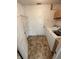 Functional laundry room featuring a washing machine, shelving, and practical flooring at 373 Springfield Cir, Greenwood, IN 46143