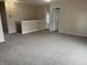 Upstairs living area featuring neutral carpet, a railing overlooking the lower level, and ample lighting at 373 Springfield Cir, Greenwood, IN 46143