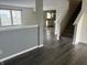Open-concept layout with sleek flooring, neutral walls, and a staircase leading to the upper level at 373 Springfield Cir, Greenwood, IN 46143