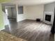A view of a vacant living room showcasing hardwood floors, a fireplace and a glass door to the backyard at 373 Springfield Cir, Greenwood, IN 46143