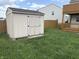 Backyard shed on a grassy lawn adjacent to the home's wooden deck at 373 Springfield Cir, Greenwood, IN 46143