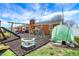 Backyard with playground, dome climber, green house, and brick home with antenna at 3940 E 600 N, Columbus, IN 47203