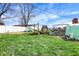 Backyard with play equipment, greenhouse, white vinyl privacy fence, and grass at 3940 E 600 N, Columbus, IN 47203