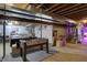 An unfinished basement featuring a foosball table, exposed ceiling beams, and other game-ready amenities at 3940 E 600 N, Columbus, IN 47203