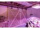 Unfinished basement showcasing DIY hydroponics setup, and rustic barn door, offering unique potential at 3940 E 600 N, Columbus, IN 47203