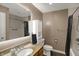 Bathroom featuring a sink, a toilet, a shower with a curtain, and a mirror at 3940 E 600 N, Columbus, IN 47203