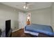 Well lit bedroom featuring wood-look flooring, ceiling fan, and a tv at 3940 E 600 N, Columbus, IN 47203