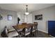 Comfortable dining room features wood floors, a wood table with six chairs, and neutral colors at 3940 E 600 N, Columbus, IN 47203