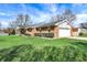 Brick ranch-style home featuring an attached garage and large, well-kept lawn at 3940 E 600 N, Columbus, IN 47203