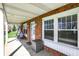 Covered front porch featuring brick accents and a cozy porch swing at 3940 E 600 N, Columbus, IN 47203