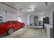 A large garage space with a red car, offering ample storage or workspace with laundry and shelving at 3940 E 600 N, Columbus, IN 47203