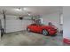A spacious two-car garage featuring an eye-catching red sports car at 3940 E 600 N, Columbus, IN 47203