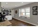 Spacious kitchen with white cabinets, granite countertops, and wood flooring, showcasing great natural light at 3940 E 600 N, Columbus, IN 47203