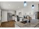 A newly renovated kitchen offers stainless steel appliances, a stylish island, and modern white cabinets at 3940 E 600 N, Columbus, IN 47203
