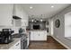 Modern kitchen featuring white cabinets, stainless appliances, granite countertops, and wood floors at 3940 E 600 N, Columbus, IN 47203