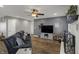 Comfortable living room featuring a fireplace, wood floors, and a ceiling fan, perfect for relaxation at 3940 E 600 N, Columbus, IN 47203