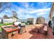 Outdoor kitchen with brick pizza oven, BBQ, picnic table, and storage sheds on brick paver patio at 3940 E 600 N, Columbus, IN 47203