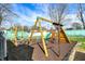 playground equipment with swings, slide, climbing features, and green house in backyard at 3940 E 600 N, Columbus, IN 47203