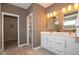 Modern bathroom featuring a double vanity with white countertops and gold fixtures at 4034 Saddle Club S Pkwy, Bargersville, IN 46106
