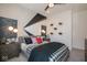 A bedroom featuring a black and gray accent wall, football decor, and plush bedding at 4034 Saddle Club S Pkwy, Bargersville, IN 46106